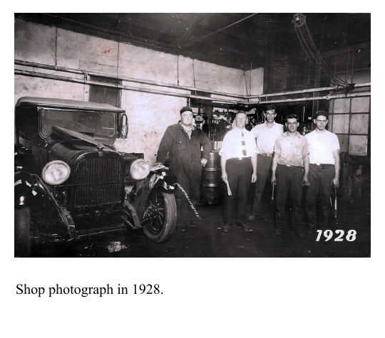 Early beginnings of a auto repair shop photograph in 1928.